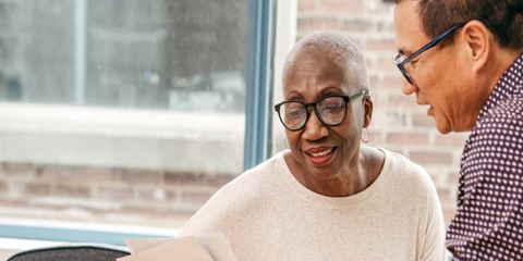 two people discussing a document